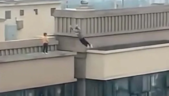 Old Video Captures Heart-Stopping Moment When Boy Leaps Across Gap Between 27-Storey Buildings In China